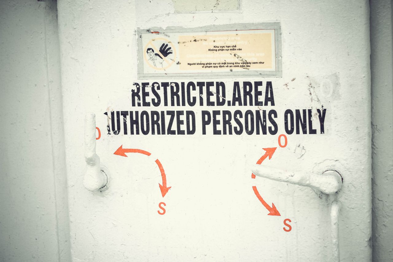Home Close-up of a restricted area door with signage emphasizing authorized access only.
